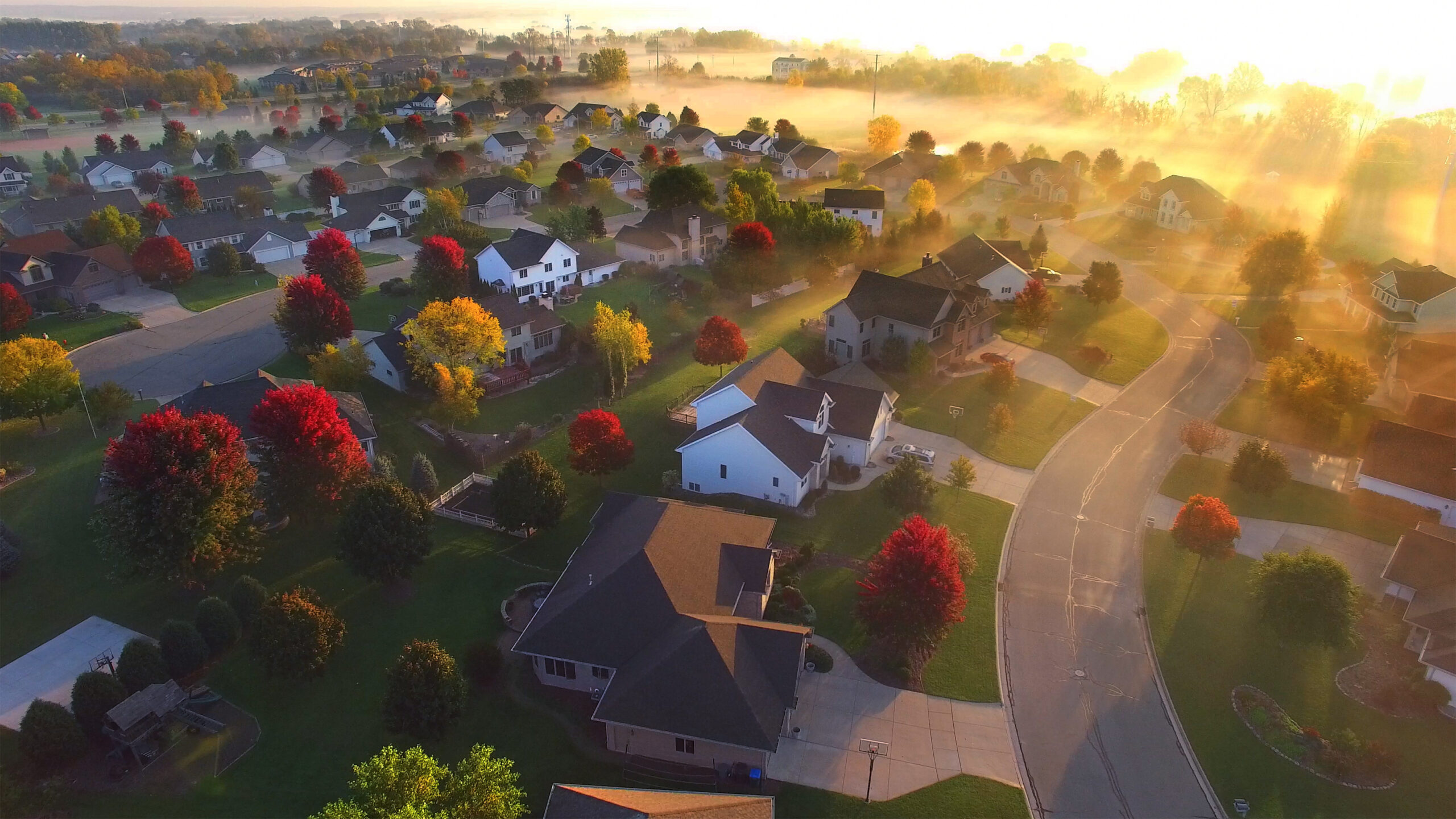 Aerial photo of neighborhood rooftops in the sun